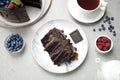 Delicious chocolate cake with fresh berries served on table, flat lay Royalty Free Stock Photo