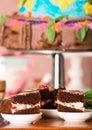 Delicious chocolate cake pieces with cream filling sitting on small plates, pastry concept Royalty Free Stock Photo