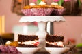 Delicious chocolate cake pieces with cream filling sitting on small plates, pastry concept Royalty Free Stock Photo