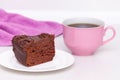 Delicious chocolate cake on plate with cup of coffee on table on light background Royalty Free Stock Photo