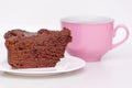 Delicious chocolate cake on plate with cup of coffee on table on light background Royalty Free Stock Photo