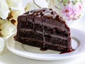 Delicious chocolate cake on white plate and a beautiful cup of tea Royalty Free Stock Photo
