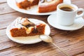 Delicious chocolate cake in white plate and one piece of chocolate cake with cup of coffee on wooden table background Royalty Free Stock Photo