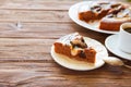 Delicious chocolate cake in white plate and one piece of chocolate cake with cup of coffee on wooden table background Royalty Free Stock Photo