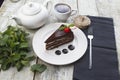Delicious chocolate cake in white plate on wooden table background, closeup Royalty Free Stock Photo