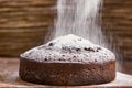 Delicious chocolate cake in white plate on wooden table background Royalty Free Stock Photo