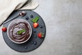 Delicious chocolate cream with berries and mint on grey table, top view. Space for text Royalty Free Stock Photo