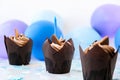 Delicious chocolate cupcakes with cream and candle. Three chocolate muffin. Birthday cake party. Boy or girl baby party Royalty Free Stock Photo