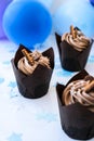 Delicious chocolate cupcakes with cream. Three chocolate muffin. Birthday cake party. Boy or girl baby party cake