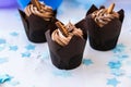 Delicious chocolate cupcakes with cream. Three chocolate muffin. Birthday cake party. Boy or girl baby party cake