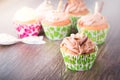 Delicious chocolate cupcakes on dark wooden table