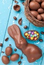 Chocolate Easter bunny, eggs and sweets on rustic background Royalty Free Stock Photo