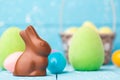 Chocolate Easter bunny, eggs and sweets on rustic background Royalty Free Stock Photo