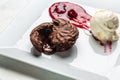 Delicious chocolate fondant or lava cake with ice cream and strawberry jam. sweet dessert Fondant au chocolate Royalty Free Stock Photo