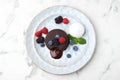 Delicious chocolate fondant served with fresh berries and ice cream on white marble table, top view Royalty Free Stock Photo