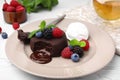 Delicious chocolate fondant served with fresh berries and ice cream on white table, closeup Royalty Free Stock Photo