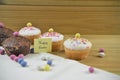 Delicious chocolate mini cakes with egg decorations and happy Easter words or text