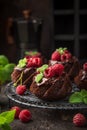 Delicious chocolate muffins with chocolate topping and fresh raspberry Royalty Free Stock Photo