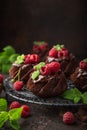 Delicious chocolate muffins with chocolate topping and fresh raspberry Royalty Free Stock Photo