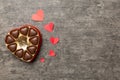 Delicious chocolate pralines in red box for Valentine's Day. Heart shaped box of chocolates top view with copy space Royalty Free Stock Photo