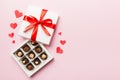 Delicious chocolate pralines in red box for Valentine's Day. Heart shaped box of chocolates top view with copy space Royalty Free Stock Photo