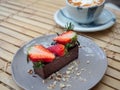 Delicious chocolate tart topped with piece of strawberries and berries Royalty Free Stock Photo