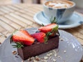 Delicious chocolate tart topped with piece of strawberries and berries Royalty Free Stock Photo