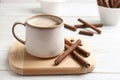 Delicious chocolate wafer rolls and cup of coffee on wooden table. Royalty Free Stock Photo
