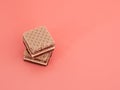 Delicious chocolate wafers with hazelnuts on a pink background. Royalty Free Stock Photo