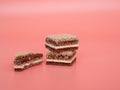 Delicious chocolate wafers with hazelnuts on a pink background. Royalty Free Stock Photo