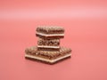 Delicious chocolate wafers with hazelnuts on a pink background. Royalty Free Stock Photo