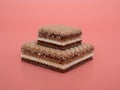 Delicious chocolate wafers with hazelnuts on a pink background. Royalty Free Stock Photo