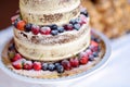 Delicious chocolate wedding cake decorated with fruits and berries Royalty Free Stock Photo