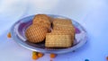 Delicious chocolate and wheat biscuits in a steel plate  on White background. Stack of round and square shape cookies with Royalty Free Stock Photo