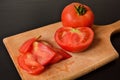 Fresh and Vibrant Chopped Tomato Slices on a Wooden Kitchen Board Royalty Free Stock Photo