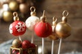 Delicious Christmas ball cake pops on blurred background, closeup Royalty Free Stock Photo