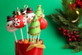 Delicious Christmas themed cake pops on green background, closeup. Space for text Royalty Free Stock Photo