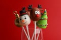 Delicious Christmas themed cake pops on red background, closeup Royalty Free Stock Photo