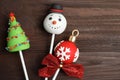 Delicious Christmas themed cake pops on wooden table, flat lay Royalty Free Stock Photo