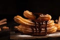 Delicious churros with chocolate and cinnamon on a dark background. - made with generative AI tools