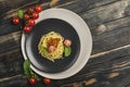Delicious classic Italian Bolognese pasta with tomatoes and Basil on a plate on a dark wooden background Royalty Free Stock Photo
