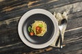 Delicious classic Italian Bolognese pasta with tomatoes and Basil on a plate on a dark wooden background Royalty Free Stock Photo