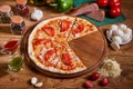 Pizza margarita with tomato sauce, fresh mozzarella, parmesan and basil on the wooden rusty background Royalty Free Stock Photo