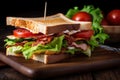 Delicious Club Sandwich with Crispy Bacon and Fresh Lettuce on a Toasted Bread, Perfect for a Quick Bite or a Casual Lunch Royalty Free Stock Photo