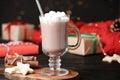 Delicious cocoa drink with marshmallows served on table