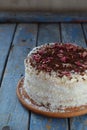 Delicious coconut layer cake - biscuit and cream on coconut cream, decorated with grated chocolate and candied rose petals Royalty Free Stock Photo