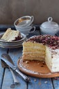 Delicious coconut layer cake - biscuit and cream on coconut cream, decorated with grated chocolate and candied rose petals