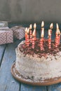 Delicious coconut layer cake - biscuit and cream on coconut cream, decorated with grated chocolate and candied rose petals. On the Royalty Free Stock Photo