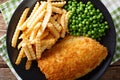 Delicious cod fish and chips with peas close-up on a plate. horizontal top view Royalty Free Stock Photo