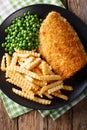Delicious cod fish and chips with peas close-up on a plate. Vert Royalty Free Stock Photo